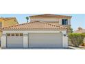 Home featuring a tile roof and a two-car garage with a two-car extension at 1501 Lucia Dr, Las Vegas, NV 89128