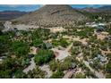 Sprawling property featuring a charming home nestled among lush trees, surrounded by picturesque mountain views at 18480 State Hwy 160, Las Vegas, NV 89161