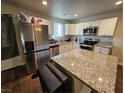 Beautiful kitchen with stainless steel appliances, white cabinets and granite countertops at 1870 Upland Ave, Pahrump, NV 89048