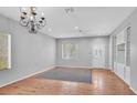 Spacious living room with hardwood floors, a decorative chandelier, and ample natural light at 1941 Williamsport St, Henderson, NV 89052