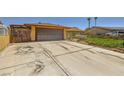 Spacious driveway leading to an attached garage, complemented by xeriscaped front yard at 1950 Abarth St, Las Vegas, NV 89142