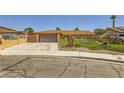 Lovely single-story home with a spacious driveway, attached garage and desert landscaping at 1950 Abarth St, Las Vegas, NV 89142