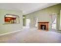 Open living room with cozy fireplace and arched view into kitchen at 2212 Sunfish Dr # C, Henderson, NV 89014