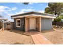 Inviting home featuring stone accents, a secure gate, and desert landscaping at 2301 Maverick St, Las Vegas, NV 89108