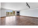 Open living space with tile floors, a fireplace, and sliding glass doors to a balcony with views of palm trees at 2857 Paradise Rd # 301, Las Vegas, NV 89109