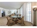 Elegant dining area featuring a round glass-top table and decorative chairs near large windows at 2877 Paradise Rd # 906, Las Vegas, NV 89109