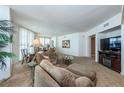 Spacious living room with a plush sofa, entertainment center, and ample natural light at 2877 Paradise Rd # 906, Las Vegas, NV 89109