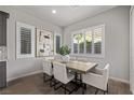 Bright dining area featuring modern light fixtures, plantation shutters, and seating for six at 30 Hilltop Crest St, Henderson, NV 89011