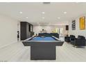 Game room with a sleek pool table, comfortable seating, and seamless flow into the adjacent living spaces at 3047 Van Buskirk Cir, Las Vegas, NV 89121
