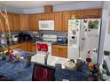 The kitchen features wood cabinets, white appliances, and a breakfast bar area at 3368 Saddleback Ct, Las Vegas, NV 89121