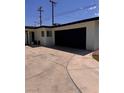 Spacious garage adjacent to the charming single-story home, complemented by a wide concrete driveway at 3900 San Angelo Ave, Las Vegas, NV 89102