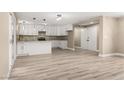 Bright open-concept kitchen and living space with white cabinets and hardwood floors at 4301 San Joaquin Ave, Las Vegas, NV 89102