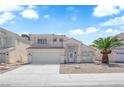 Two-story home featuring desert landscaping, a two-car garage, and a charming entrance at 4604 Barnes Ct, Las Vegas, NV 89147