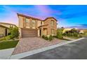 Charming two-story home with a three-car garage, paver driveway, and manicured lawn at 4702 Amazing View St, Las Vegas, NV 89129