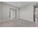 Open-concept living area with ceramic tile flooring and neutral paint at 4829 E Beacon Ridge Dr, Pahrump, NV 89061