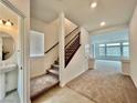 Open entryway with tiled floors, carpeted stairs, and access to the living area at 5699 Woodchester Ave, Las Vegas, NV 89139