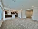 Open concept living room flows to the kitchen and features lots of natural light at 5699 Woodchester Ave, Las Vegas, NV 89139