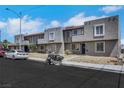Street view of attached townhomes with stucco exteriors, desert landscaping, and parking at 6008 Pebble Beach Blvd, Las Vegas, NV 89108
