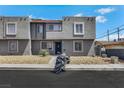 Townhome featuring stucco exterior, security bars on the first-floor windows and desert landscaping at 6008 Pebble Beach Blvd, Las Vegas, NV 89108