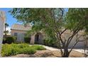 Inviting single-story house with mature landscaping and a well-maintained front yard at 6113 Desert Haven Rd, Las Vegas, NV 89130