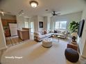 Spacious living room area with a comfortable couch, ottoman, and stylish decor at 6313 Snap Ridge St # 201, North Las Vegas, NV 89081