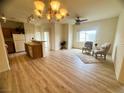 Open-concept living area with lots of sunlight, hardwood flooring, and comfortable seating at 6313 Snap Ridge St # 201, North Las Vegas, NV 89081