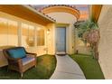 Inviting front entrance with a cozy seating area and well-maintained walkway and garden at 7252 Royal Melbourne Dr, Las Vegas, NV 89131