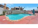 Back yard featuring an in-ground pool with rock waterfall feature and privacy wall at 7500 Sea Spray Ave, Las Vegas, NV 89128