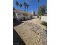 The backyard features desert landscaping with rocks and a patio area, perfect for relaxing at 79 Magical Mystery Ln, Henderson, NV 89074