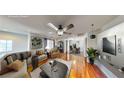 The bright living room is furnished with hardwood floors and a ceiling fan at 9116 Tailor Made Ave, Las Vegas, NV 89149