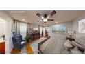The primary bedroom offers hardwood floors, a ceiling fan, and bright natural light at 9116 Tailor Made Ave, Las Vegas, NV 89149