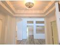 Bright foyer with modern light fixture, recessed ceiling, and beautiful hardwood floors, leading to the rest of the home at 9329 Fresh Spring Dr, Las Vegas, NV 89134
