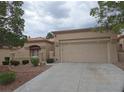 Inviting single-story home featuring desert landscaping, and a two-car garage, set beneath a cloudy sky at 9329 Fresh Spring Dr, Las Vegas, NV 89134