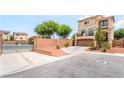 Two-story tan stucco home with an attached garage at 9704 Morgan Creek Ct, Las Vegas, NV 89141