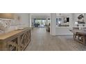 Open-concept entryway with wood-look tile flooring leading to the living room and outdoor patio at , Las Vegas, NV 89148