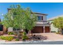 Spacious two-story home boasts a three-car garage, brick accents, and well-maintained landscaping at 10420 Loma Portal Ave, Las Vegas, NV 89166