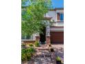 Charming two-story home with brick accents around the entrance, and a well-manicured yard at 10420 Loma Portal Ave, Las Vegas, NV 89166