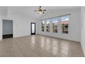 Open concept living area with large windows and tile floors with a neutral paint palette and lots of natural light at 10550 W Alexander Rd # 2079, Las Vegas, NV 89129