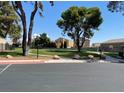 Scenic community park view showing a lush green space with mature trees and walking paths at 1667 Marion Bennet Dr, Las Vegas, NV 89106