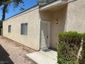 Home exterior featuring a classic design with a light-colored stucco finish and well-maintained landscaping at 1667 Marion Bennet Dr, Las Vegas, NV 89106