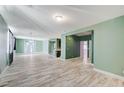 Spacious living room with wood-look tile flooring, neutral walls, and abundant natural light at 1829 Fighting Falcon Ln, North Las Vegas, NV 89031