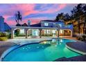 Stunning pool with a covered patio and lush landscaping, offering a perfect oasis for relaxation and entertainment at 1984 Troon Dr, Henderson, NV 89074