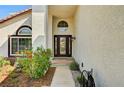 Welcoming front entrance with decorative glass door and colorful landscaping at 2036 Deer Springs Dr, Henderson, NV 89074