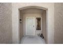 Inviting entryway with an arched opening, security door, and sidelight window with neutral decor at 2216 Spring Water Dr, Las Vegas, NV 89134