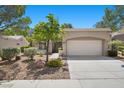 Charming single-story home with a two-car garage, well-manicured landscaping, and a spacious driveway at 2216 Spring Water Dr, Las Vegas, NV 89134