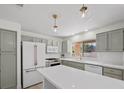 Beautiful kitchen with stainless steel appliances, quartz countertops, pendant lights, and ample cabinet space at 2216 Spring Water Dr, Las Vegas, NV 89134