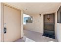 Outdoor entryway with secure door, window, and covered walkway that leads into the residence at 3827 Desert Marina Dr # 211, Laughlin, NV 89029
