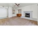 Spacious living room showcasing a fireplace and a ceiling fan at 3827 Desert Marina Dr # 211, Laughlin, NV 89029