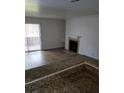 Bright living room featuring modern flooring, a cozy fireplace, and access to a private outdoor space at 4050 Pacific Harbors Dr # 149, Las Vegas, NV 89121