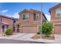 Inviting two-story home with a two-car garage and easy to maintain desert landscaping at 4609 Hearts Desire Ave, Las Vegas, NV 89115